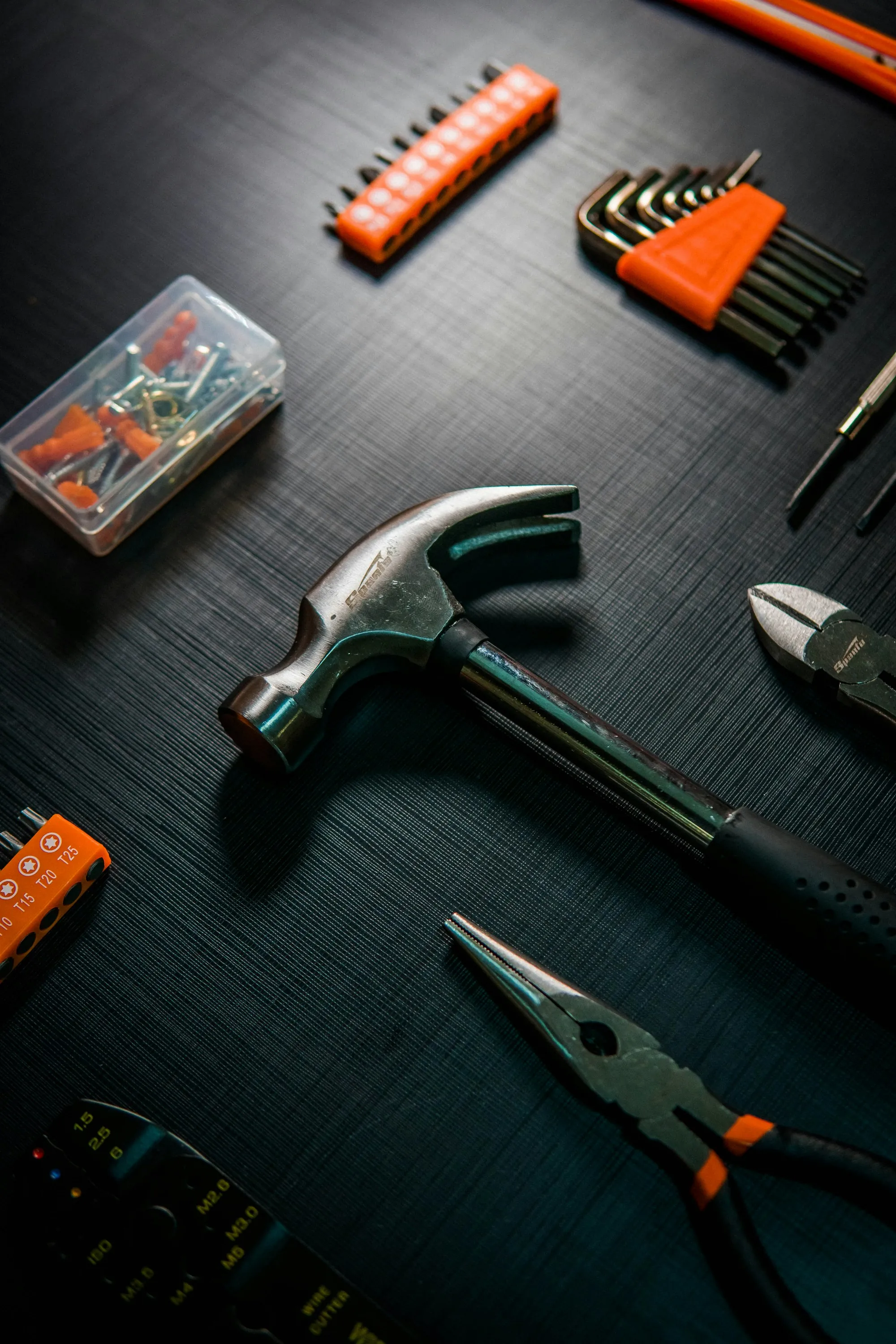 Claw hammer and cutters on a dark work surface